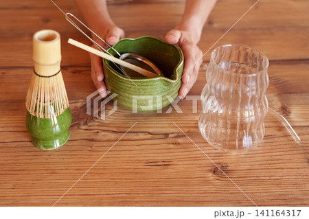 Preparing tools and glass for iced mango matcha latte at home Preparing tools and glass for iced mango matcha latte at home 141164317