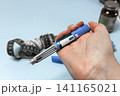 Hand holding Ozempic injection pen for diabetes treatment. 141165021