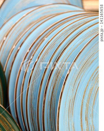 Beautiful light blue ceramic plates on supermarket shelves, close up of kitchen tableware for home use 141165658