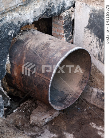 Large city heating pipeline under repair with section of metal pipe removed exposing work chamber for maintenance and urban infrastructure improvement Large city heating pipeline under repair with section of metal pipe removed exposing work chamber for maintenance and urban infrastructure improvement 141165678