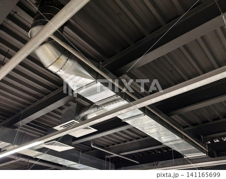 High ceiling of production hall with metal pipelines integrated with ventilation for air distribution and safety compliance 141165699