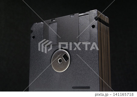 Collection of black floppy disks from the 1990s technology era 141165718