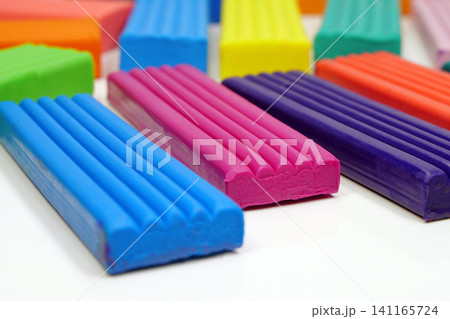 Bright plasticine ready for shaping and modeling fun. Colorful plasticine pieces ready for creative play 141165724