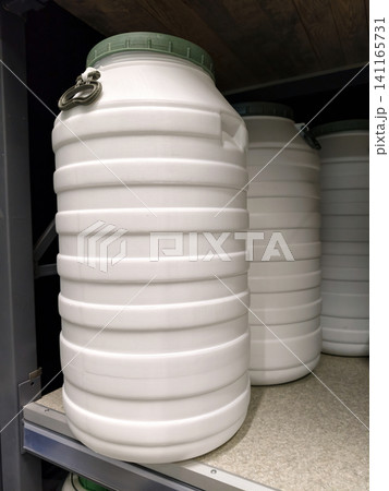 Big white plastic drums arranged neatly on shelves in a hardware store for customers Big white plastic drums arranged neatly on shelves in a hardware store for customers 141165731