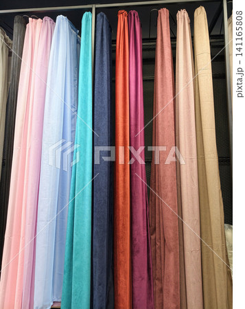Fabric curtains in multiple designs and colors displayed on racks Fabric curtains in multiple designs and colors displayed on racks 141165808