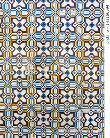 Traditional Portuguese azulejo wall tiles featuring a vibrant geometric pattern in blue yellow and black creating a historic Mediterranean aesthetic 141166994