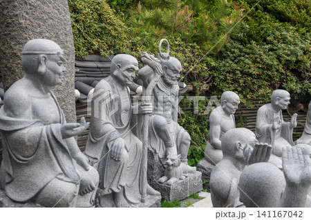 Stone monk statues at seaside Haedong Yonggungsa Temple, Busan 141167042