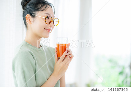 トマトジュースを飲む若い女性 トマトジュースを飲む若い女性 141167566