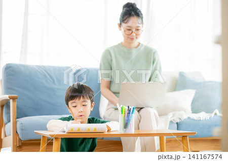 勉強する小学生と働くママ 勉強する小学生と働くママ 141167574