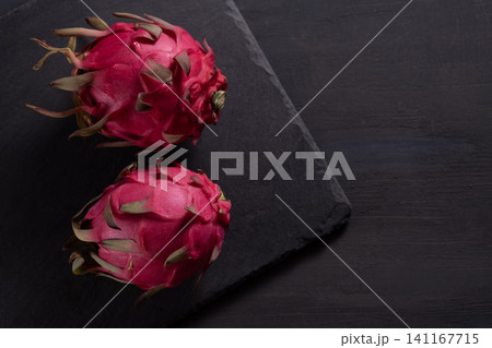 Dragon fruit on a grey granite background Dragon fruit on a grey granite background 141167715