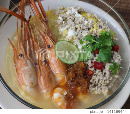 Tom Yum Kung Noodle Bowl with River Prawns, Minced Pork, Poached Egg, Lime, Fresh Herbs, Chili, and Creamy Thai Spicy Broth Tom Yum Kung Noodle Bowl with River Prawns, Minced Pork, Poached Egg, Lime, Fresh Herbs, Chili, and Creamy Thai Spicy Broth 141169444