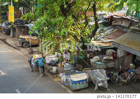 People collecting and sorting recyclables on a street in Vietnam People collecting and sorting recyclables on a street in Vietnam 141170177
