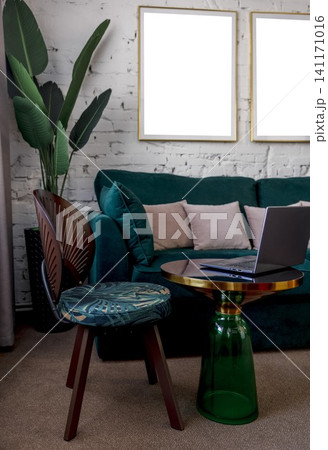 laptop standing on round coffee table in modern living room, green velvet sofa wooden chair, houseplant stylish apartment workspace scene, remote work, interior design, home office laptop standing on round coffee table in modern living room, green velvet sofa wooden chair, houseplant stylish apartment workspace scene, remote work, interior design, home office 141171016