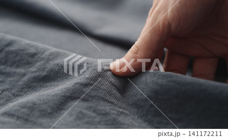 man manually check corduroy blue color cotton fabric for clothing with hands man manually check corduroy blue color cotton fabric for clothing with hands 141172211