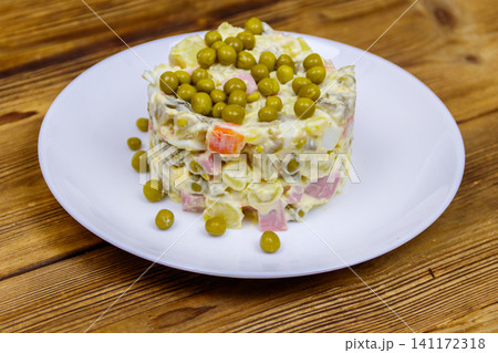 Traditional Russian festive salad Olivier on wooden table Traditional Russian festive salad Olivier on wooden table 141172318