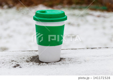 Cup of coffee on a snow covered table at winter 141172328