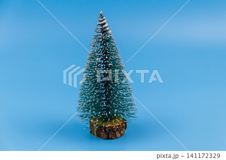 Christmas tree on a pastel blue background. Christmas or New Year concept. Minimal design Christmas tree on a pastel blue background. Christmas or New Year concept. Minimal design 141172329