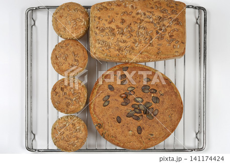 Homemade Seeded Bread and Buns on Cooling Rack Homemade Seeded Bread and Buns on Cooling Rack 141174424