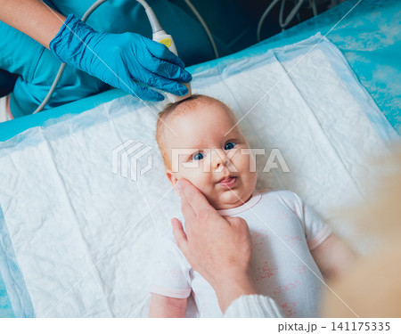 Doctor and little boy patient. Ultrasound equipment. Diagnostics. Sonography. Doctor and little boy patient. Ultrasound equipment. Diagnostics. Sonography. 141175335