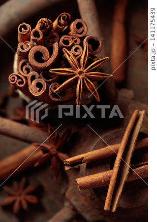Cinnamon sticks and anise on a rusty background. Cinnamon sticks and anise on a rusty background. 141175439