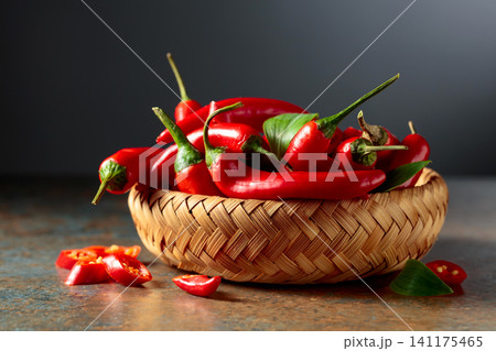 Red hot chili peppers in wicker dish. Red hot chili peppers in wicker dish. 141175465