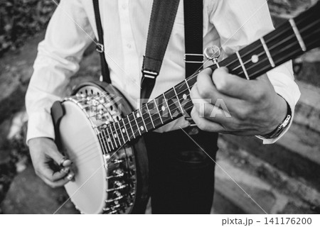View of musician playing banjo at the street 141176200