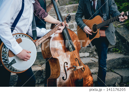 Trio of musicians with a guitar, banjo and contrabass Trio of musicians with a guitar, banjo and contrabass 141176205