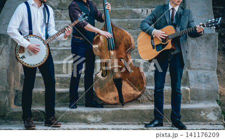 Trio of musicians with a guitar, banjo and contrabass Trio of musicians with a guitar, banjo and contrabass 141176209