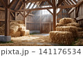 Barn interior with haystacks, wooden beams, and sunlight 141176534