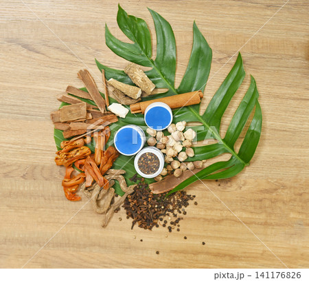 Traditional Thai herbal ingredients used in an ancient Thai inhaler recipe, featuring aromatic medicinal plants and natural remedies on a rustic wooden background. Traditional Thai herbal ingredients used in an ancient Thai inhaler recipe, featuring aromatic medicinal plants and natural remedies on a rustic wooden background. 141176826