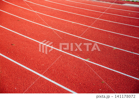 Athletics stadium running track red lines marks. 141178072