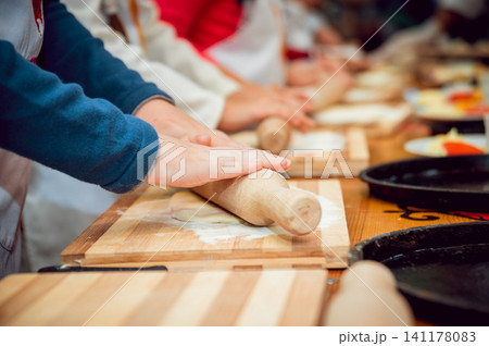 Preparing pizza. Cooks hands and table close-up. Preparing pizza. Cooks hands and table close-up. 141178083