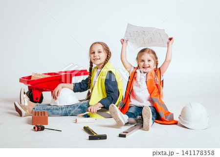 Little girls on the white background. Construction Little girls on the white background. Construction 141178358