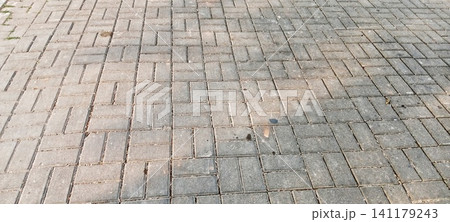 Herringbone-patterned paving block texture 141179243