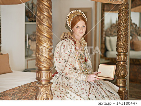 Woman, royal and book with portrait for renaissance, royalty aesthetic and reading on palace bed. Monarch, wealthy person or elegant dress for cosplay, regal or medieval knowledge in the castle Woman, royal and book with portrait for renaissance, royalty aesthetic and reading on palace bed. Monarch, wealthy person or elegant dress for cosplay, regal or medieval knowledge in the castle 141180447