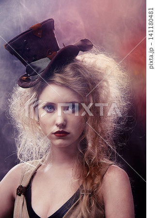 Face, woman and theatre as actress with smoke for musical with creative makeup for entertainment, artist and fashion. Portrait, female person and outfit for performance, rehearsal in dark background Face, woman and theatre as actress with smoke for musical with creative makeup for entertainment, artist and fashion. Portrait, female person and outfit for performance, rehearsal in dark background 141180481