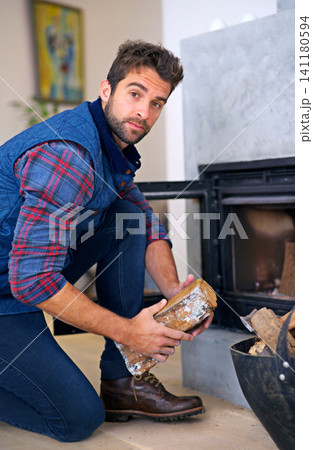 Fireplace, wood and portrait of man in home for heat, warmth and light in winter. Flame, burning hearth and person with firewood, logs and fire for comfortable, cozy and relaxing house in living room Fireplace, wood and portrait of man in home for heat, warmth and light in winter. Flame, burning hearth and person with firewood, logs and fire for comfortable, cozy and relaxing house in living room 141180594