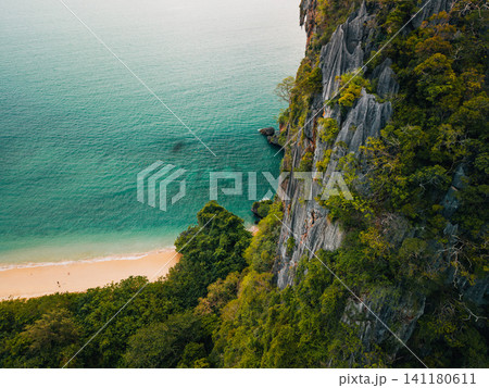 Aerial view of a sheer limestone karst cliff dropping into the t 141180611