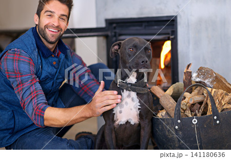 Fireplace, dog and portrait of man with fire in home for heat, warmth and light in winter. Flame, wood and person with pet bonding with firewood for comfort, cozy and relaxing house in living room Fireplace, dog and portrait of man with fire in home for heat, warmth and light in winter. Flame, wood and person with pet bonding with firewood for comfort, cozy and relaxing house in living room 141180636