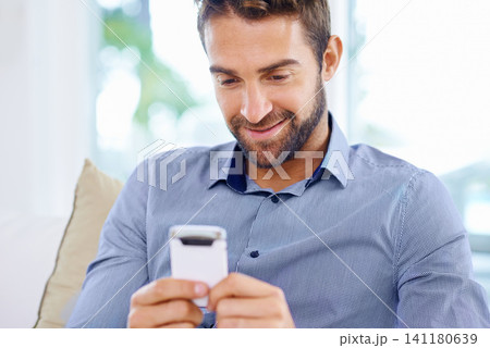 Businessman, phone and typing an email in home, communication and networking for company. Male person, freelancer and reading a notification on app for conversation, website and internet for info 141180639