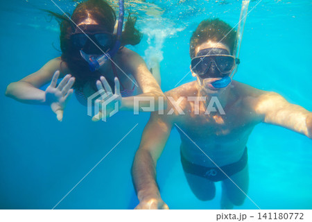 Scuba diving, underwater or couple swimming on holiday to explore for marine adventure, hobby or vacation. Mask, divers or people at sea or ocean for travel, tropical environment or outdoor activity Scuba diving, underwater or couple swimming on holiday to explore for marine adventure, hobby or vacation. Mask, divers or people at sea or ocean for travel, tropical environment or outdoor activity 141180772