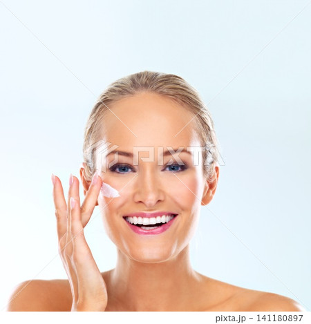 Woman, cream and portrait for skincare, dermatology and makeup for wellness, antiage and clean in studio. Model person and beautiful with smile for moisture and lipstick for hygiene on face Woman, cream and portrait for skincare, dermatology and makeup for wellness, antiage and clean in studio. Model person and beautiful with smile for moisture and lipstick for hygiene on face 141180897