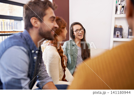 Friends, conversation and smile in cafe for talk, relax or break and together for weekend. Young people, group and happy for social bonding, chatting or gossip for unwind, cheerful and sitting 141180944