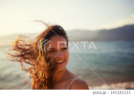 Happy, beach and woman in summer for holiday, vacation and weekend outdoors at sunset. Nature, travel and face of person with smile for relaxing, adventure and freedom by ocean on tropical island Happy, beach and woman in summer for holiday, vacation and weekend outdoors at sunset. Nature, travel and face of person with smile for relaxing, adventure and freedom by ocean on tropical island 141181113