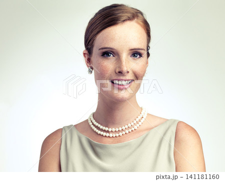 Portrait, fashion and beauty of happy woman in studio isolated on a gray background. Face, freckles and skin of young person in vintage clothes for style, retro or elegance with necklace in Ireland Portrait, fashion and beauty of happy woman in studio isolated on a gray background. Face, freckles and skin of young person in vintage clothes for style, retro or elegance with necklace in Ireland 141181160