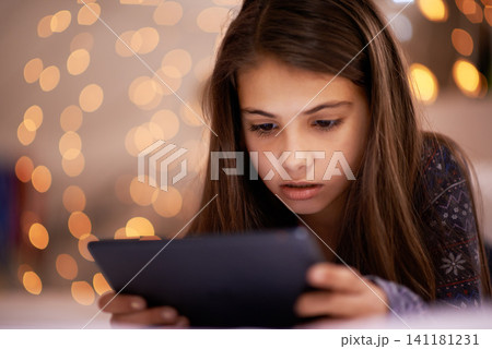 Home, night or girl with tablet for streaming, playing games or watching videos on a movie website. Internet, house or female child with technology to download online or social media app to relax 141181231