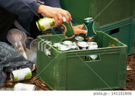 Liquor, person and hands with drinks, beer and beverage product for drinking a can in party. Closeup, outdoor or tin container for liquid, alcohol or crate in case package on ground or floor by trash 141181606