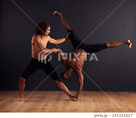 Practice, people and contemporary in dance studio for training, competition and routine. Teamwork, balance and diverse young men for professional, performance arts and workout with dark background Practice, people and contemporary in dance studio for training, competition and routine. Teamwork, balance and diverse young men for professional, performance arts and workout with dark background 141181627