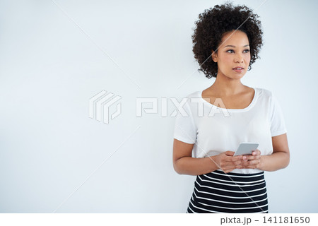 Business woman, thinking and phone on a wall or white background for chat and communication ideas and solution. African worker, employee or person with mobile and search for inspiration on mockup 141181650