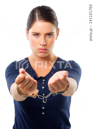 Woman, portrait and handcuffs in studio for arrest of prisoner for justice of law and crime. Criminal or thief, serious for custody and restrained for jail for illegal counterfeiting in Venezuela Woman, portrait and handcuffs in studio for arrest of prisoner for justice of law and crime. Criminal or thief, serious for custody and restrained for jail for illegal counterfeiting in Venezuela 141181768